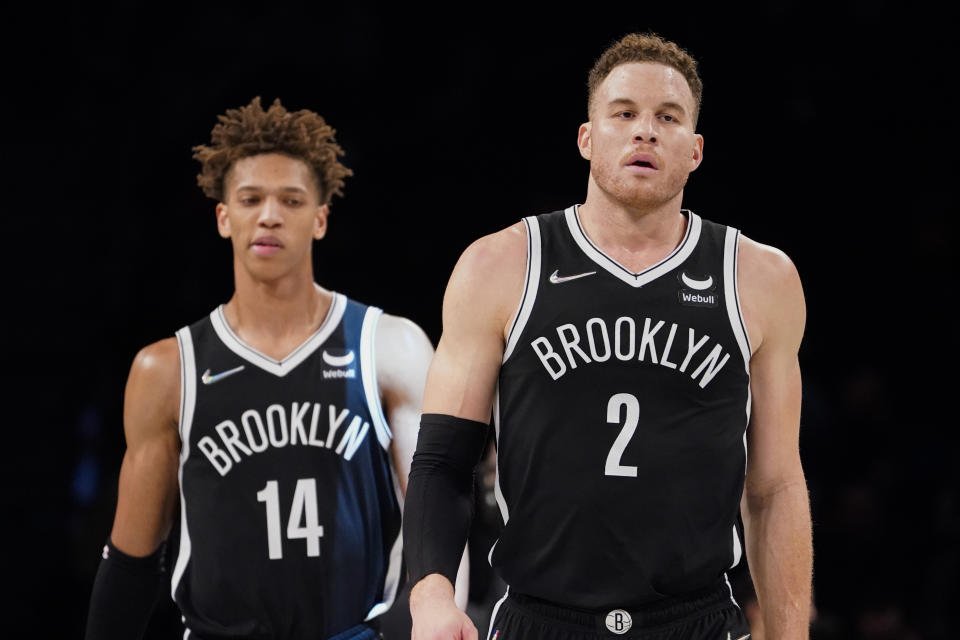 Brooklyn Nets forward Blake Griffin (2) and forward Kessler Edwards (14) react to a 26 point scoring deficit during the first half of an NBA basketball game against the Boston Celtics, Tuesday, Feb. 8, 2022, in New York. (AP Photo/John Minchillo)