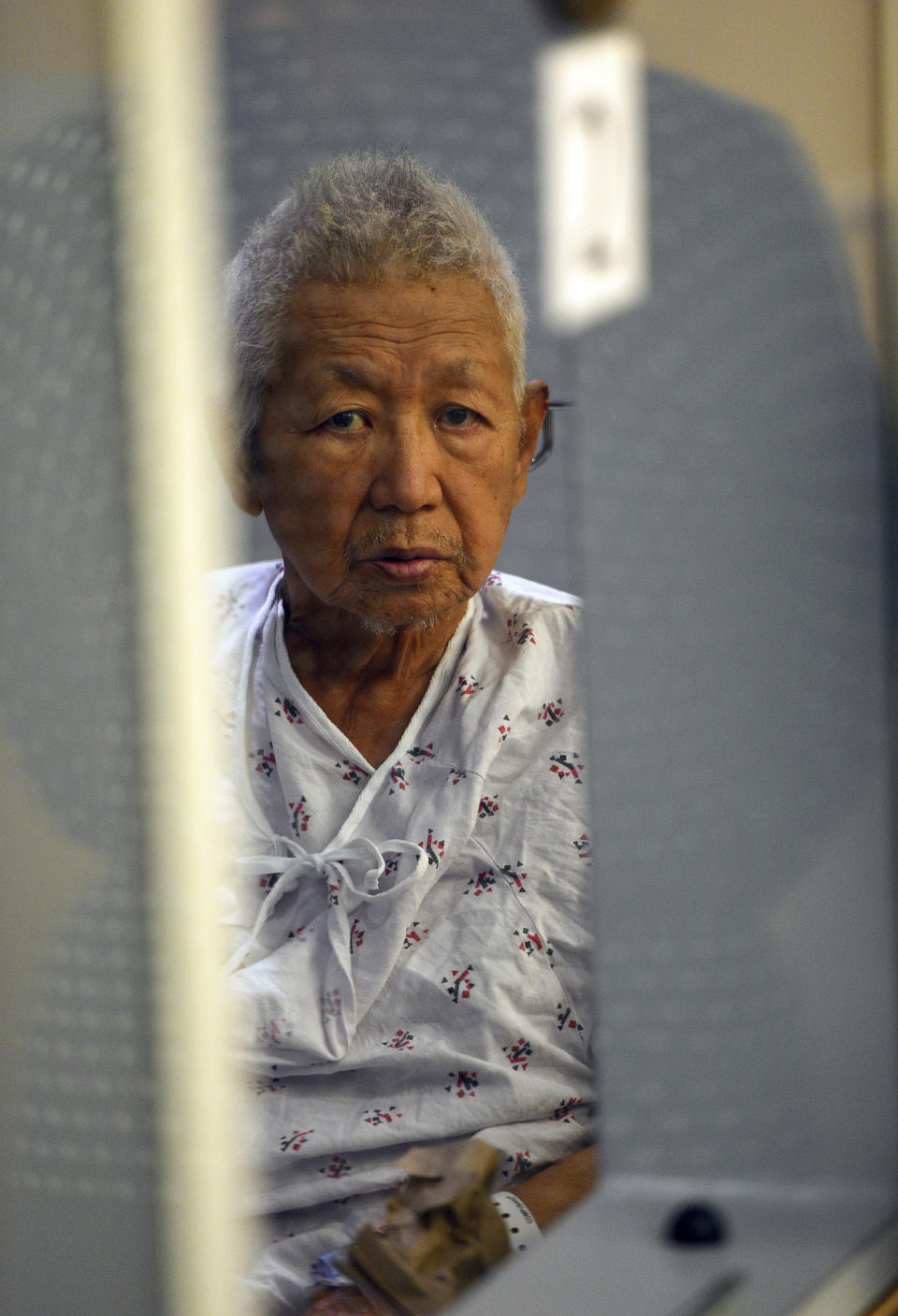 FILE - In this July 9, 2018 file photo, Thomas Kim sits in a hospital gown in a wheelchair as his arraignment is postponed in Superior Court in Long Beach, Calif. Kim, 77, charged with shooting to death a fire captain at a Southern California senior housing facility has died Sunday, Aug. 5, 2018, in custody from an existing medical condition, authorities said Monday, Aug. 6. (Scott Varley/The Orange County Register via AP, Pool, File)