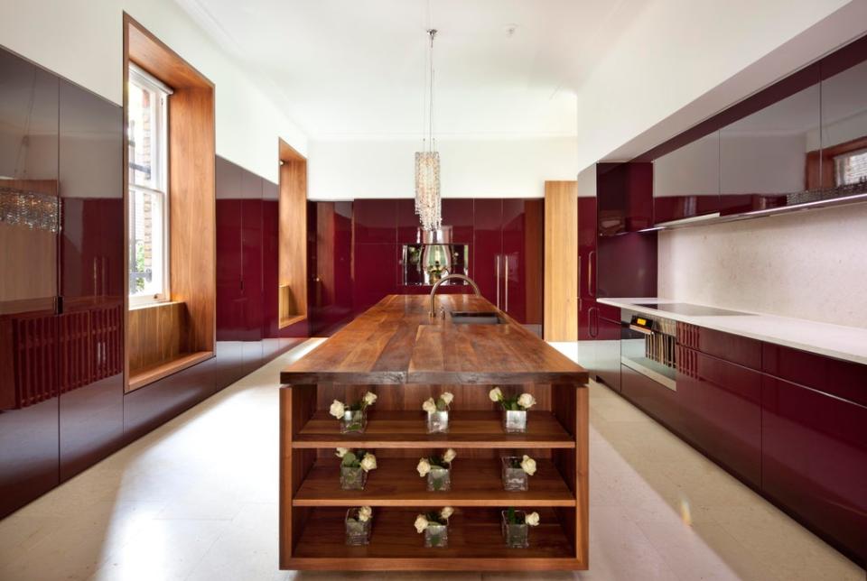The main kitchen has a large walnut-topped central island with concealed seating for eight people (Aston Chase)