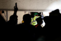 <p>A rescue worker searches through rubble in a floodlit search for students at Enrique Rebsamen school in Mexico City, Mexico Sept. 20, 2017. (Photo: Carlos Jasso/Reuters) </p>