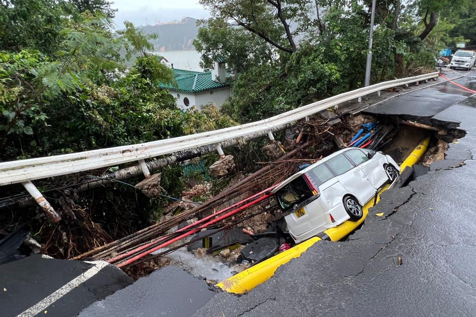 A vehicle in a collapsed section of road in Hong Kong on September 8, 2023