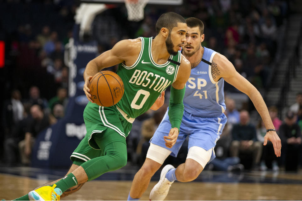 Boston Celtics guard Jayson Tatum (0) drives against Minnesota Timberwolves forward Juancho Hernangomez (41) in the first quarter of an NBA basketball game Friday, Feb. 21, 2020, in Minneapolis. (AP Photo/Andy Clayton-King)