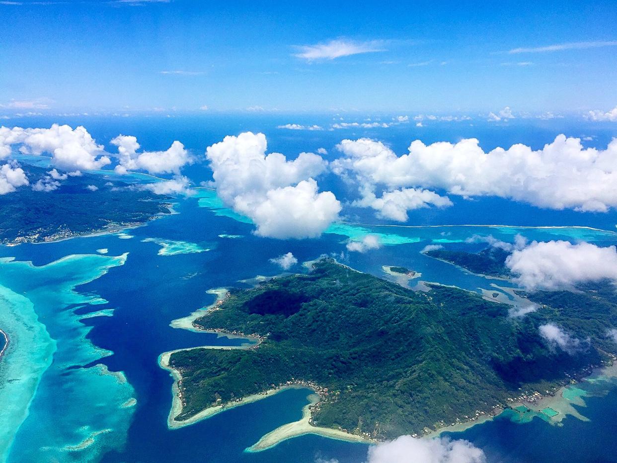 When flying away from Bora Bora island, the Aerial View of the Paradise Bora Bora Island is truly amazing. Here is  another beautiful island seen from the air when flying from Bora Bora Island to Tahiti.