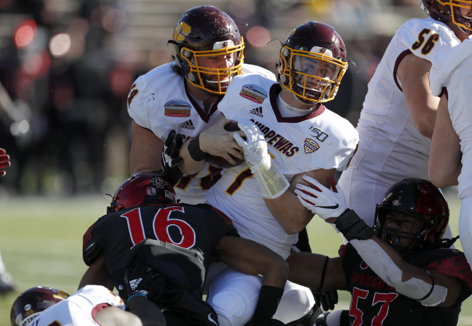 Central Michigan quarterback Tommy Lazzaro (7) is sacked by San Diego State cornerback Luq Barcoo (16) and defensive lineman Keshawn Banks (57) during the first half of the New Mexico Bowl NCAA college football game on Saturday, Dec. 21, 2019 in Albuquerque, N.M. (AP Photo/Andres Leighton)