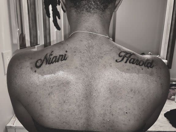 Boler shows her final tattoo with her mother and father's name on each shoulder.