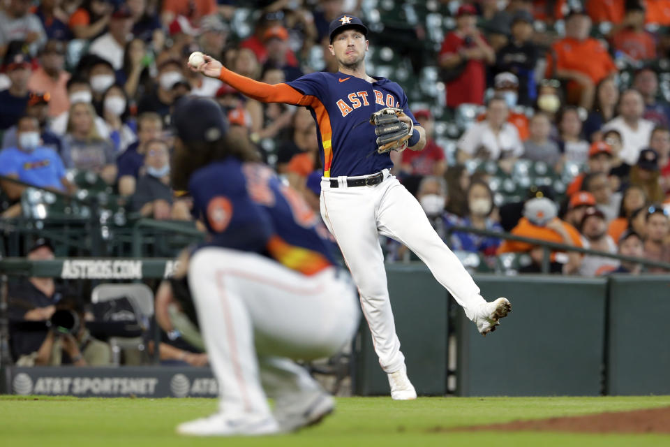 Houston Astros third baseman Alex Bregman throws to first base over pitcher Lance McCullers Jr. for an out against Los Angeles Angels' Kurt Suzuki during the fifth inning of a baseball game Sunday, Sept. 12, 2021, in Houston. (AP Photo/Michael Wyke)