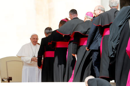 Pope Francis greets bishops and cardinals at the end of the weekly general audience in the Vatican, May 22, 2019. REUTERS/Remo Casilli