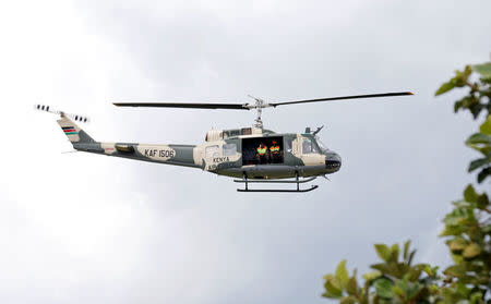 A military helicopter is seen during a recovery mission after a dam burst, which unleashed water at nearby homes, in Solio town near Nakuru, Kenya May 10, 2018. REUTERS/Thomas Mukoya