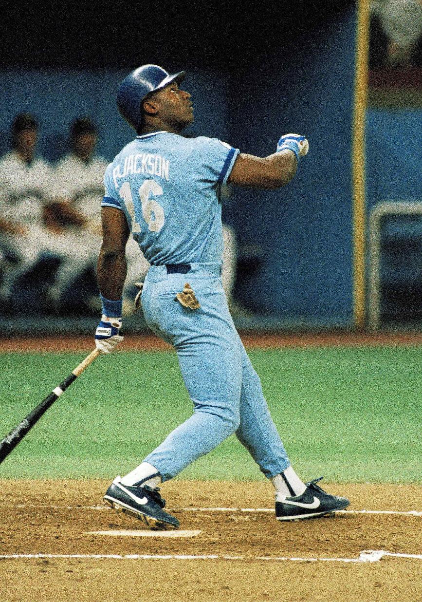 FILE - In this Sept. 21, 1987, file photo, Kansas City Royals' Bo Jackson flies out during the third inning of a baseball game against the Seattle Mariners at the Kingdome in Seattle, Sept. 21, 1987. Florida State's Jameis Winston will become the sixth Heisman winner to play college baseball after winning the award and the first since Bo Jackson in 1986. Winston is the Seminoles' closer, will DH and play outfield. (AP Photo/Gary Stewart, File)