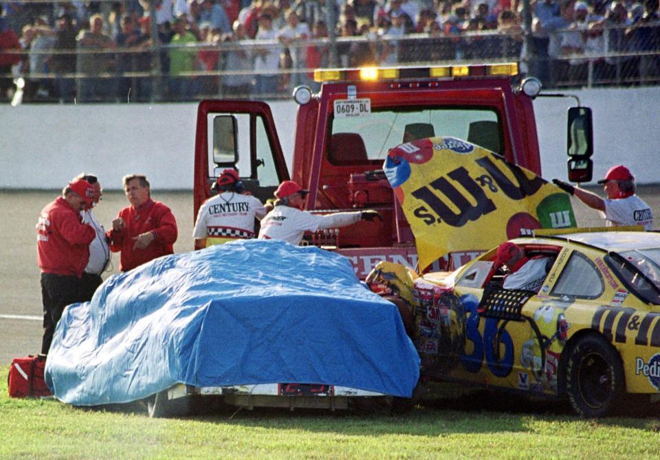 FILE - In this Feb. 18, 2001 file photo, safety workers cover Dale Earnhardt's (3) Chevrolet after crashing with Ken Schrader (36) during the Daytona 500 auto race at the Daytona International Speedway in Daytona Beach, Fla. Earnhardt, the greatest stock car star of his era, was killed in a crash on the last turn of the last lap of the race that day as he tried to protect Michael Waltrip's victory. (AP Photo/Greg Suvino, File