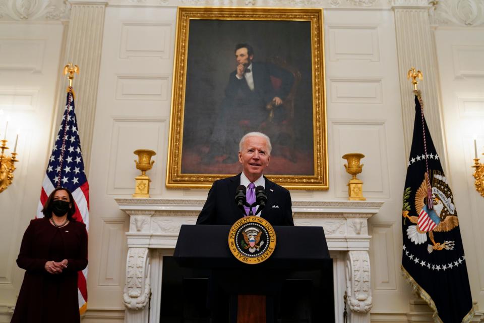 President Joe Biden arrives to speak about the coronavirus, accompanied by Vice President Kamala Harris, in the State Dinning Room of the White House, Thursday, Jan. 21, 2021, in Washington.
