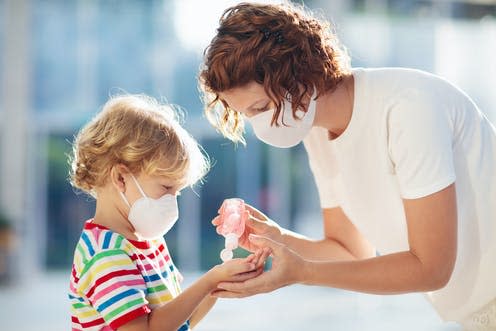 <span class="caption">Conspiracy theories increase the likelihood that people won't follow expert advice.</span> <span class="attribution"><a class="link " href="https://www.shutterstock.com/image-photo/family-kids-face-mask-shopping-mall-1641857584" rel="nofollow noopener" target="_blank" data-ylk="slk:Shutterstock;elm:context_link;itc:0;sec:content-canvas">Shutterstock</a></span>