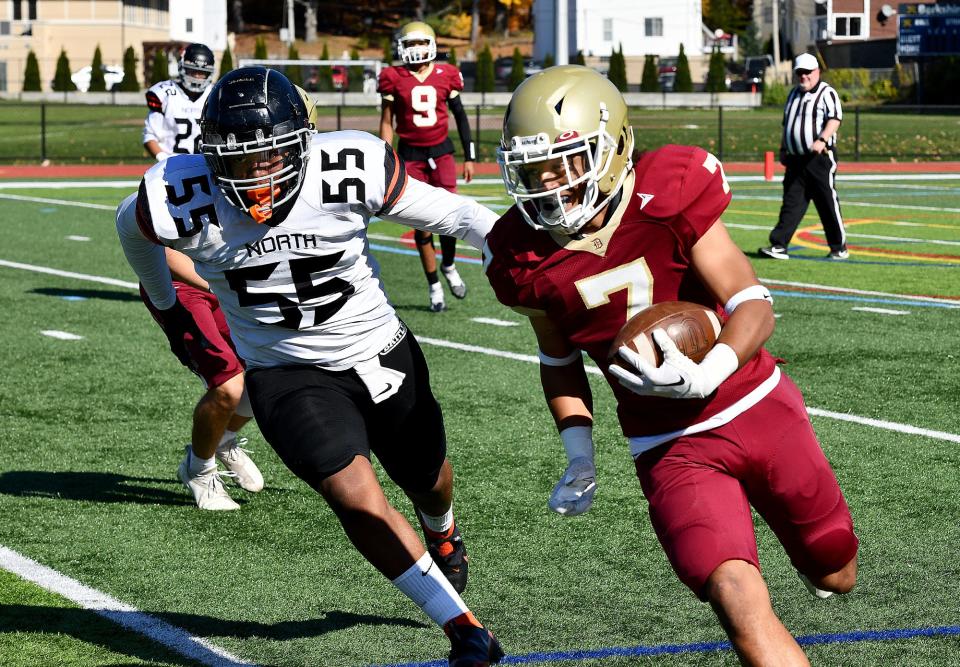 Doherty's Malachi Burke rushes as North's Andell Williams moves in.