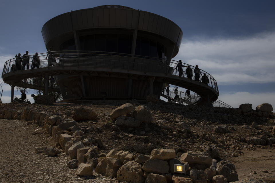 In this Tuesday, March 12, 2019 photo, tourists visit the archaeological site of Tel Shiloh in the West Bank. Deep in the West Bank, an Israeli settlement has transformed the archaeological site into a biblical tourist attraction that is drawing tens of thousands of Evangelical Christian visitors each year. Critics say the site promotes a narrow interpretation of history popular with Israeli settlers and their Christian supporters. (AP Photo/Sebastian Scheiner)