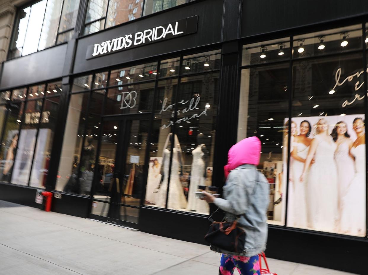 Person walks by exterior of David's Bridal store