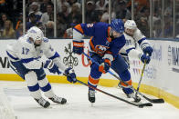 Tampa Bay Lightning left wing Alex Killorn (17) and center Steven Stamkos (91) fight for control over the puck against New York Islanders defenseman Nick Leddy (2) during the third period of Game 3 of the NHL hockey Stanley Cup semifinals, Thursday, June 17, 2021, in Uniondale, N.Y. (AP Photo/Frank Franklin II)