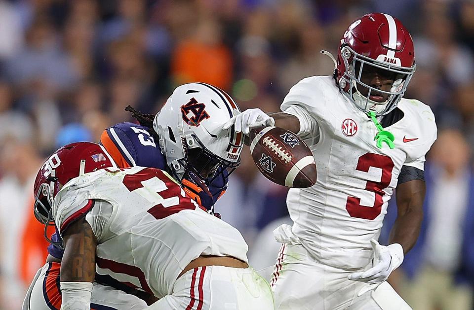 AUBURN, ALABAMA - NOVEMBER 25: Rivaldo Fairweather #13 of the Auburn Tigers fails to pull in this reception as he is hit by Jihaad Campbell #30 and Terrion Arnold #3 of the Alabama Crimson Tide during the fourth quarter at Jordan-Hare Stadium on November 25, 2023 in Auburn, Alabama. (Photo by Kevin C. Cox/Getty Images)