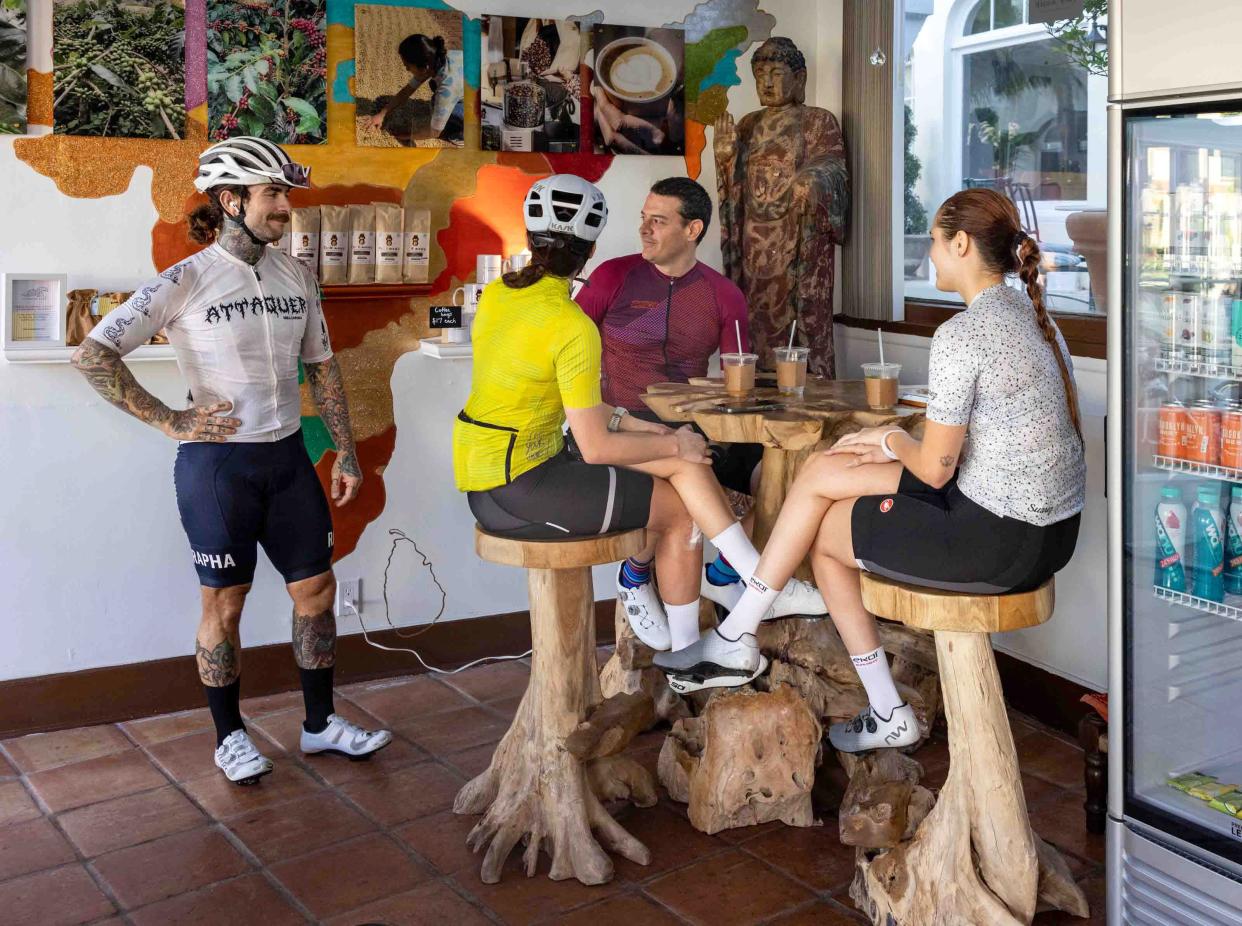 A group of bikers take a break from their morning ride inside the Chik Monk Estate Coffee shop in Palm Beach, January 19, 2023.