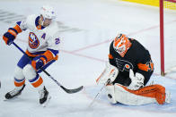 Philadelphia Flyers' Brian Elliott, right, blocks shot as New York Islanders' Brock Nelson looks on during the third period of an NHL hockey game, Sunday, April 18, 2021, in Philadelphia. (AP Photo/Matt Slocum)