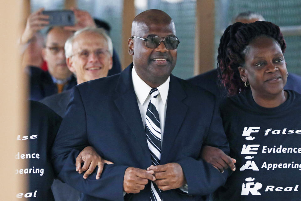 Curtis Flowers flanked by sister Priscilla Ward, right, exits the Winston Choctaw Regional Correctional Facility in Louisville, Miss., Monday, Dec. 16, 2019. Flowers' murder conviction was overturned by the U.S. Supreme Court for racial bias, and he was granted bond by a circuit judge and is free, with some conditions, for the first time in 22 years. (AP Photo/Rogelio V. Solis)