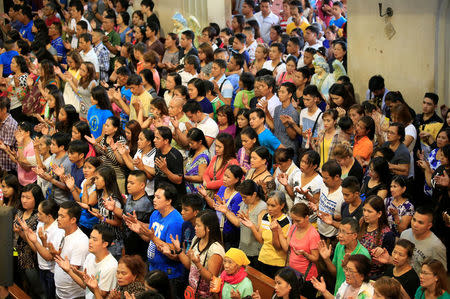 Filipino Catholic devotees gesture as they sing a religious song during a mass at a National Shrine of Our Mother of Perpetual Help in Baclaran, Paranaque city, metro Manila, Philippines September 18, 2016. REUTERS/Romeo Ranoco