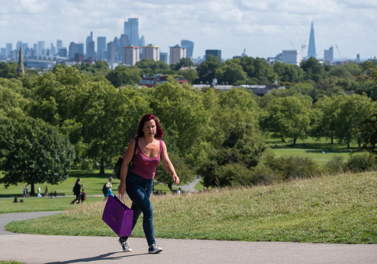 People enjoying a period of sunshine on Primrose Hill in London, as blustery showers are expected across the UK over the next few days, while hopes of a Bank Holiday heatwave have been dashed by forecasters. (Photo by Dominic Lipinski/PA Images via Getty Images)