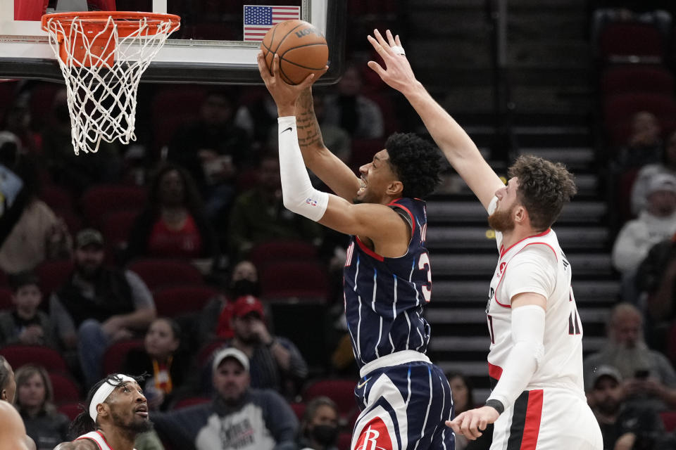 Houston Rockets center Christian Wood, second from right, drives to the basket as Portland Trail Blazers center Jusuf Nurkic, right, defends during the first half of an NBA basketball game, Friday, Jan. 28, 2022, in Houston. (AP Photo/Eric Christian Smith)