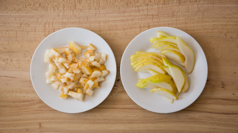 cut and sliced pears on separate white plates 