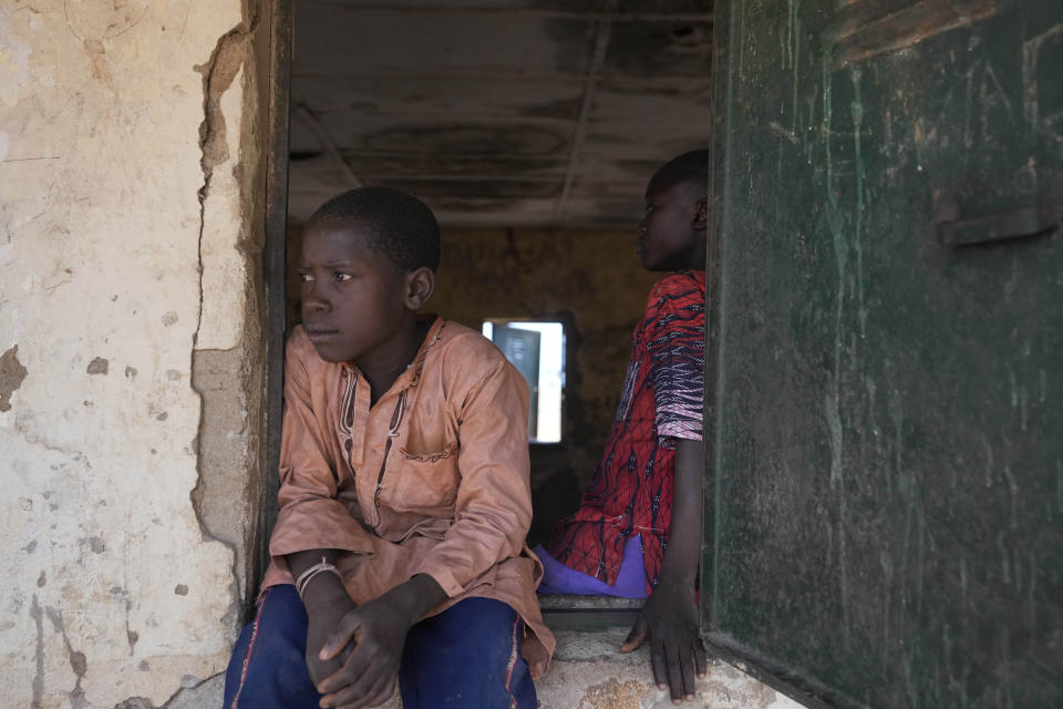 A child sits on a window of a class room at the LEA Primary and Secondary School Kuriga in Kuriga, Kaduna, Nigeria, Saturday, March 9, 2024. The kidnapping on Thursday was only one of three mass kidnappings in northern Nigeria since late last week, a reminder of the security crisis that has plagued Africa's most populous country. No group claimed responsibility for any of the abductions but two different groups are blamed. (AP Photo/Sunday Alamba)