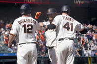 San Francisco Giants' Brandon Crawford, center, celebrates after a three-run home run that also scored Alex Dickerson (12) and Wilmer Flores (41) during the sixth inning of a baseball game against the Colorado Rockies in San Francisco, Saturday, April 10, 2021. (AP Photo/Jeff Chiu)