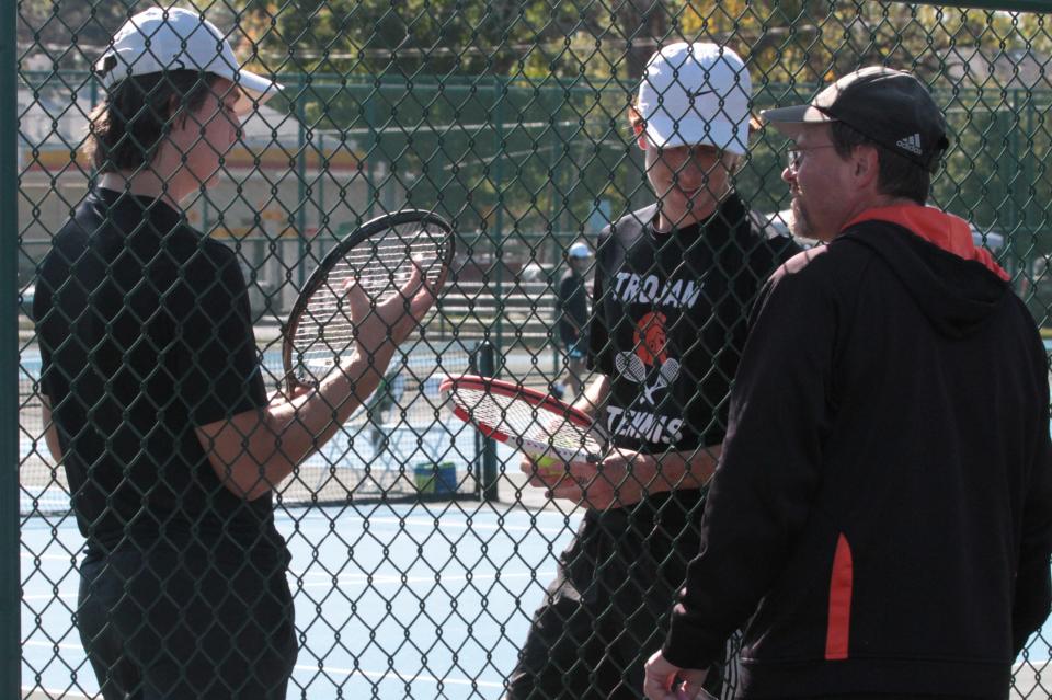 The Sturgis first doubles team of Luke Frost and Drake Harker chat with coach George Earl during a break in their match on Wednesday.