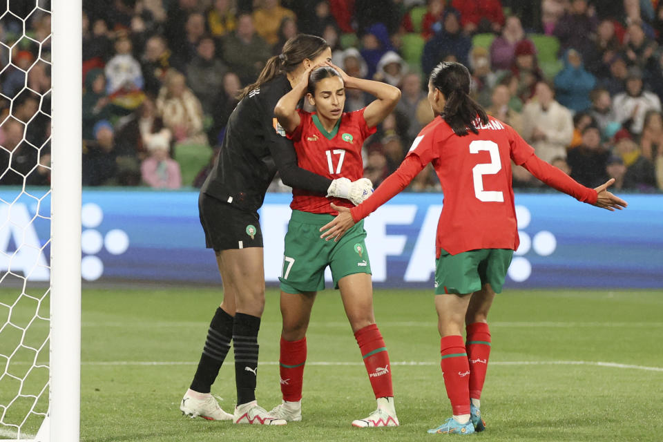 Morocco's goalkeeper Khadija Er-Rmichi, left, embraces teammate Hanane Ait El Haj after she scored an own goal during the Women's World Cup Group H soccer match between Germany and Morocco in Melbourne, Australia, Monday, July 24, 2023. (AP Photo/Hamish Blair)