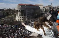 Spectators look down from the balcony of the Newseum building as students and gun control advocates hold the "March for Our Lives" event demanding gun control after recent school shootings at a rally in Washington, U.S., March 24, 2018. REUTERS/Leah Millis