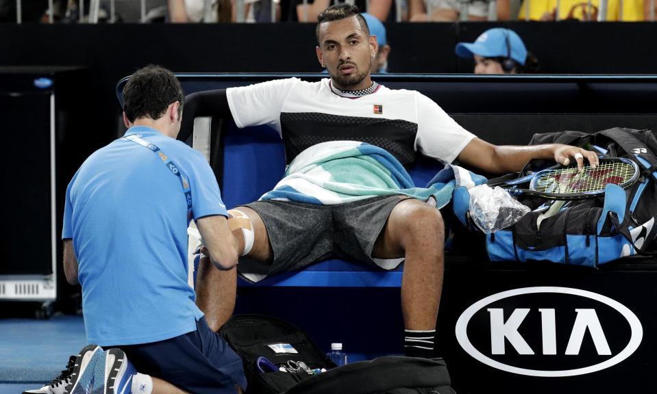 Nick Kyrgios receives treatment from a trainer during his first-round defeat by Canada’s Milos Raonic.
