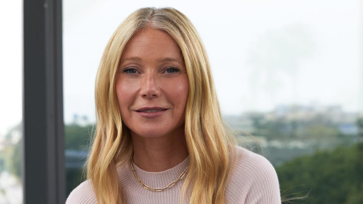 a blond woman in a white sweater