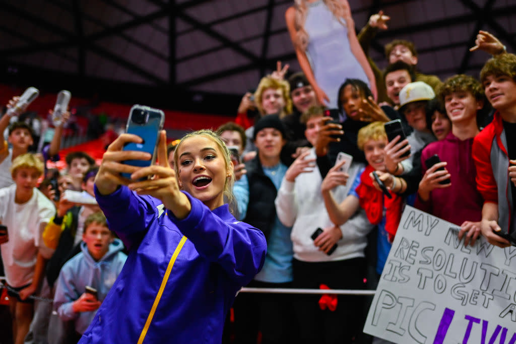 Olivia Dunne of LSU takes a 'selfie' with fans after a meet against Utah at Jon M. Huntsman Center in Salt Lake City, Utah.