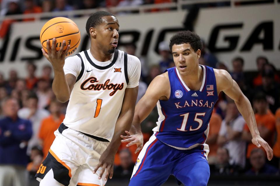 Oklahoma State Cowboys guard Bryce Thompson (1) tries to get opast Kansas Jayhawks guard Kevin McCullar Jr. (15) during a men's college basketball game between the Oklahoma State University Cowboys and the Kansas Jayhawks at Gallagher-Iba Arena in Stillwater, Okla., Tuesday, Feb. 14, 2023. 