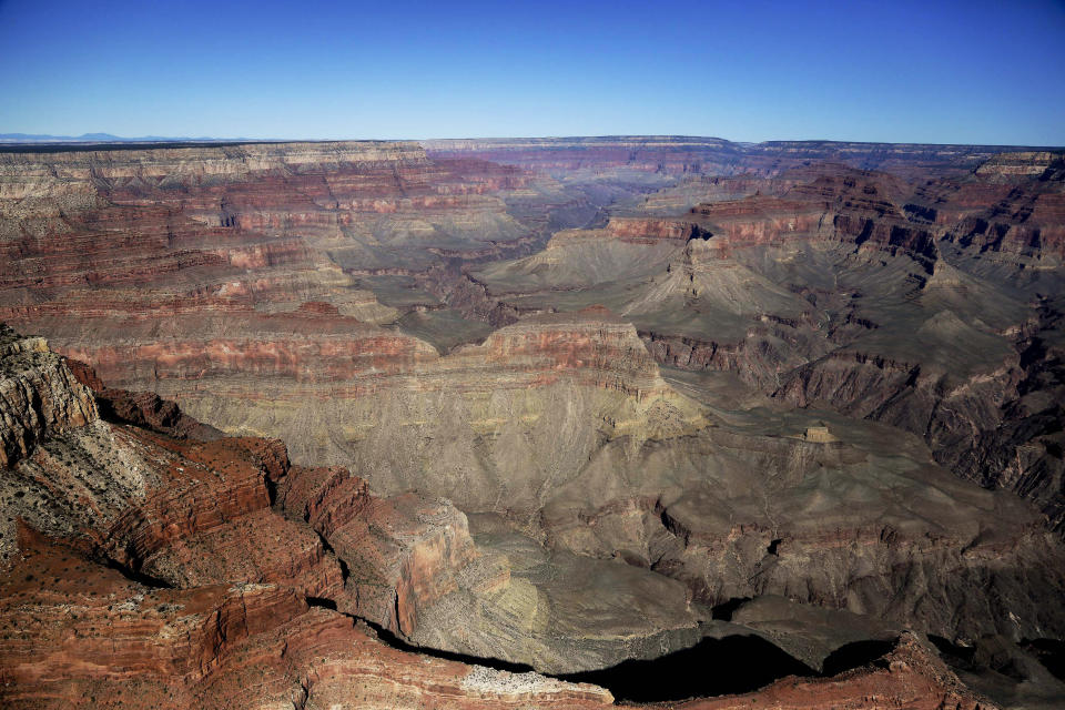 FILE - The Grand Canyon National Park is covered in the morning sunlight as seen from a helicopter near Tusayan, Ariz., on Oct. 5, 2013. The U.S. Senate has unanimously approved the nomination of Charles "Chuck" Sams III as National Park Service director, which will make him the first Native American to lead the agency that oversees more than 131,000 square miles of parks and other landmarks. (AP Photo/Julie Jacobson, File)