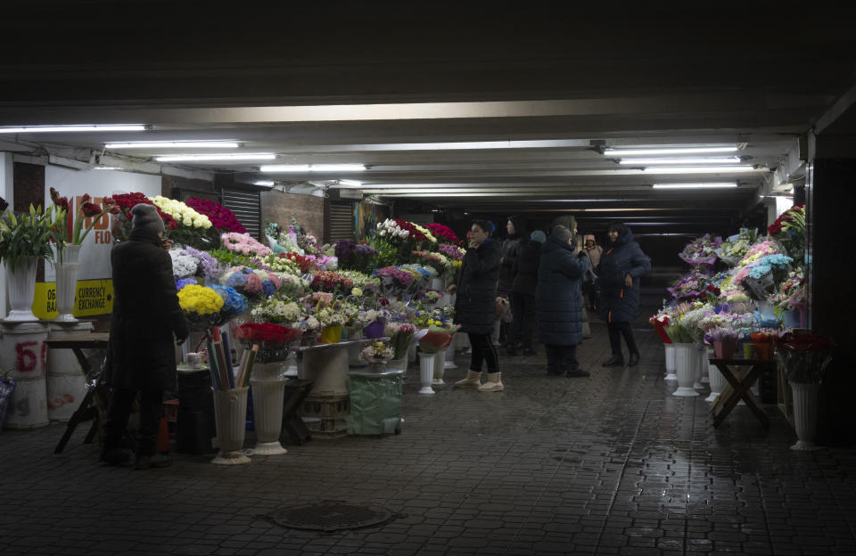 Flower sellers chat in an underground crosswalk in central Kyiv, Ukraine, Monday, Dec. 12, 2022. Ukraine has been fighting with the Russian invaders since Feb. 24 for over nine months. (AP Photo/Efrem Lukatsky)