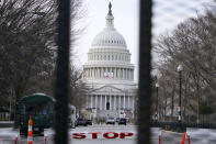 The U.S. Capitol is seen through security fencing on Saturday, Jan. 16, 2021, in Washington as security is increased ahead of the inauguration of President-elect Joe Biden and Vice President-elect Kamala Harris. (AP Photo/John Minchillo)