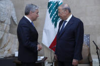 In this photo released by Lebanon's official government photographer Dalati Nohra, Lebanese President Michel Aoun, right, meets with Canadian Foreign Minister FranÁois-Philippe Champagne, at the presidential palace, in Baabda, east of Beirut, Lebanon, Thursday, Aug. 27, 2020. (Dalati Nohra via AP)