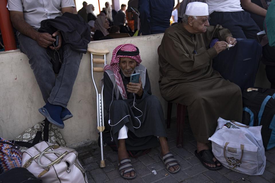Palestinians wait to cross into Egypt at the Rafah border crossing in the Gaza Strip, on Monday, Oct. 16, 2023. | Fatima Shbair, Associated Press