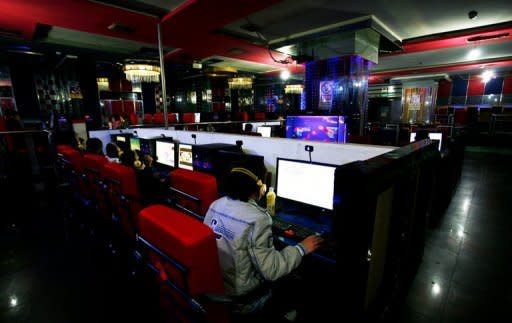 Illustration photo shows people at an Internet cafe in China. China has shut down websites, made a string of arrests and punished two popular microblogs after rumours of a coup linked to a major scandal that brought down a top politician