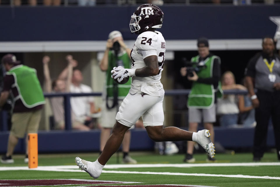 Texas A&M linebacker Chris Russell Jr. (24) run for a turnover touchdown during the second half of an NCAA college football game against Arkansas, Saturday, Sept. 30, 2023,in Arlington, Texas. (AP Photo/LM Otero)