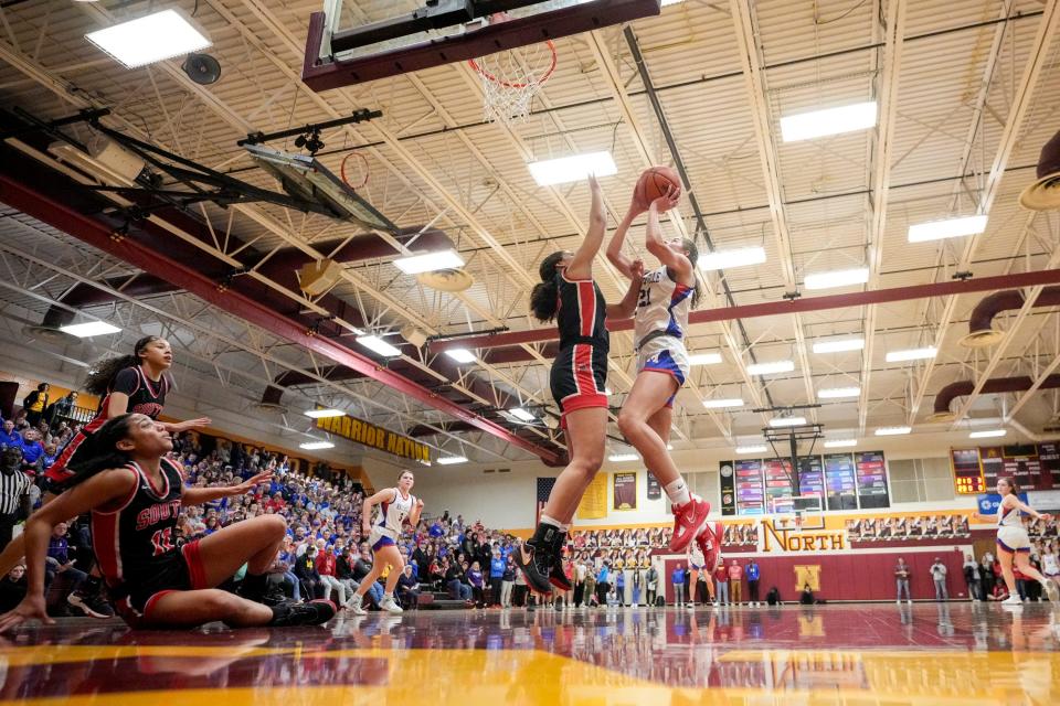 Marysville's JoJo Eberhart puts up a shot over Westerville South's Nelia Guice during a Division I regional semifinal Tuesday night at Westerville North.