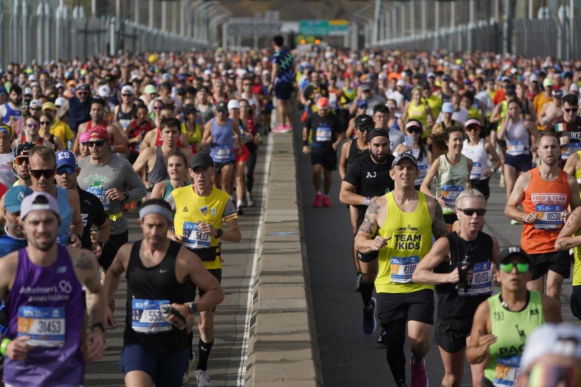 Runners cross the Verrazzano-Narrows Bridge on Nov. 6, 2022 at the start of the New York City Marathon. The world’s population is projected to hit an estimated 8 billion people on Tuesday, Nov. 15, according to a United Nations projection. (AP Photo/Seth Wenig)