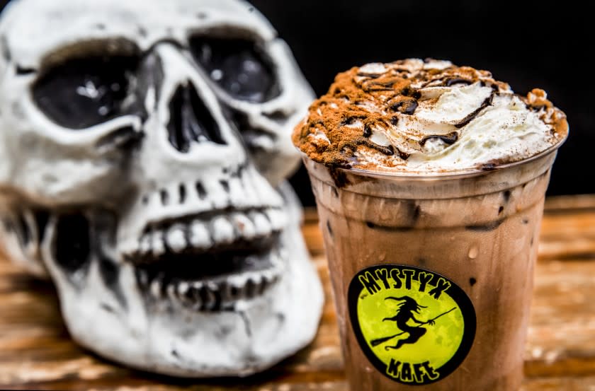 EAST LOS ANGELES, CA - OCTOBER 07, 2021: Mocha coffee with sin & whips (cinnamon and whipped cream) is on the menu at goth-themed coffee stand, Mystyx Kafe, on the corner of Rowan Ave. and Cesar Chavez Ave. in East Los Angeles. Mystyx Kafe is run by founder Julian Anguiano and his girlfriend, Sol Castillo. (Mel Melcon / Los Angeles Times)