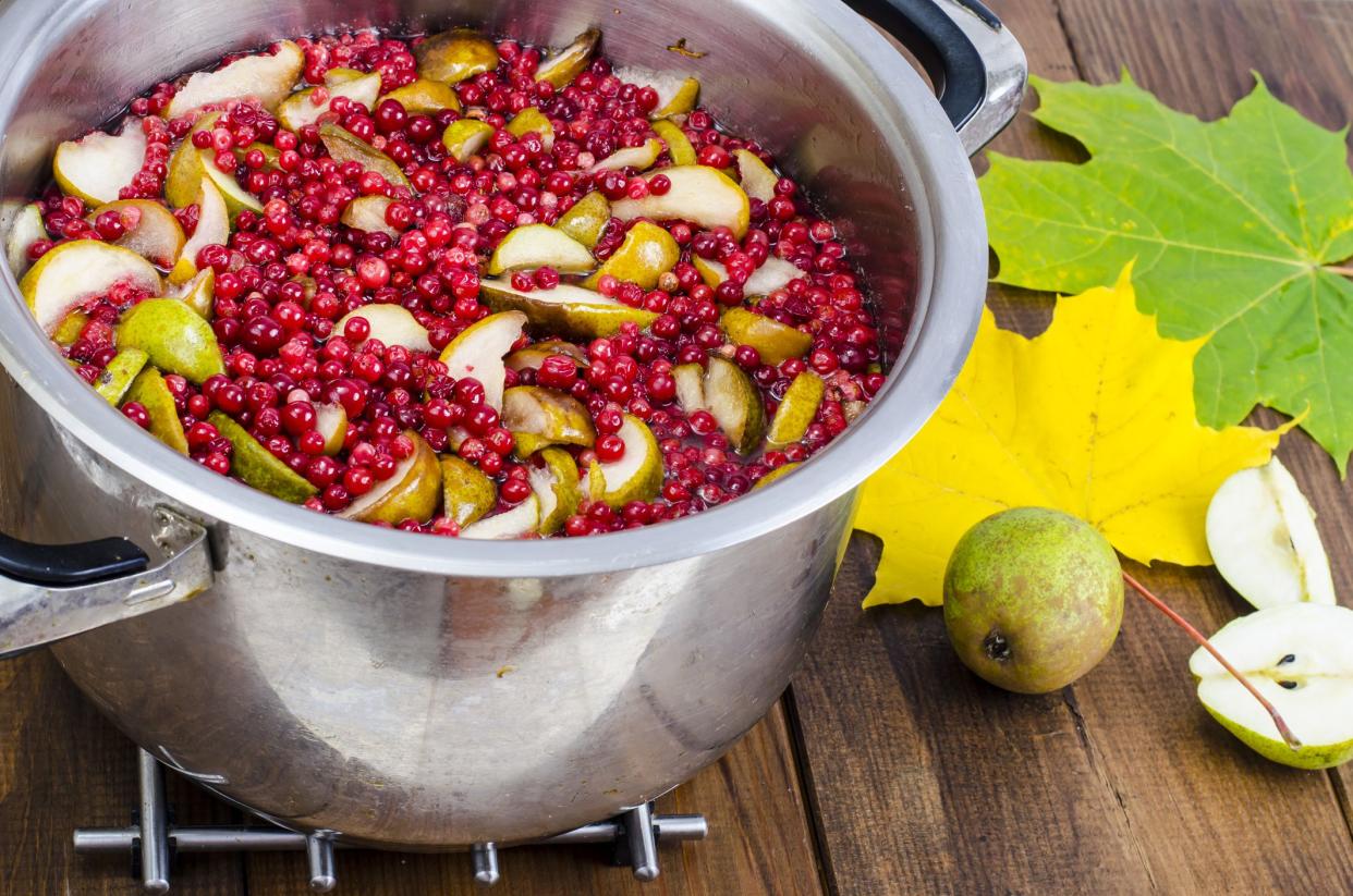 Cooking  fresh pear and cranberry. Studio Photo