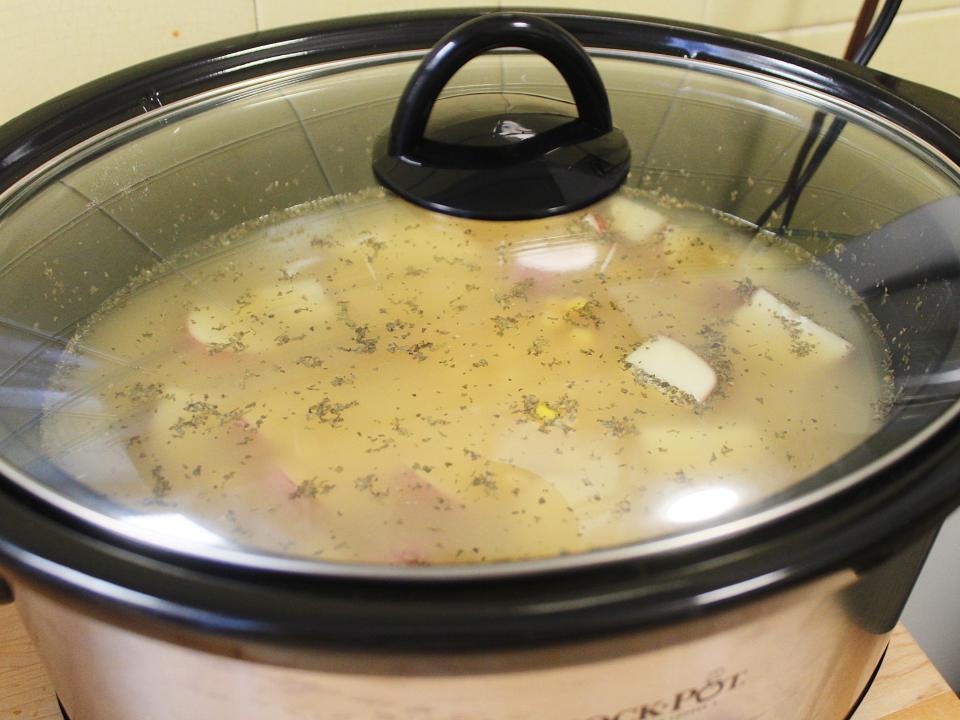 corn chowder in slow cooker with the lid on