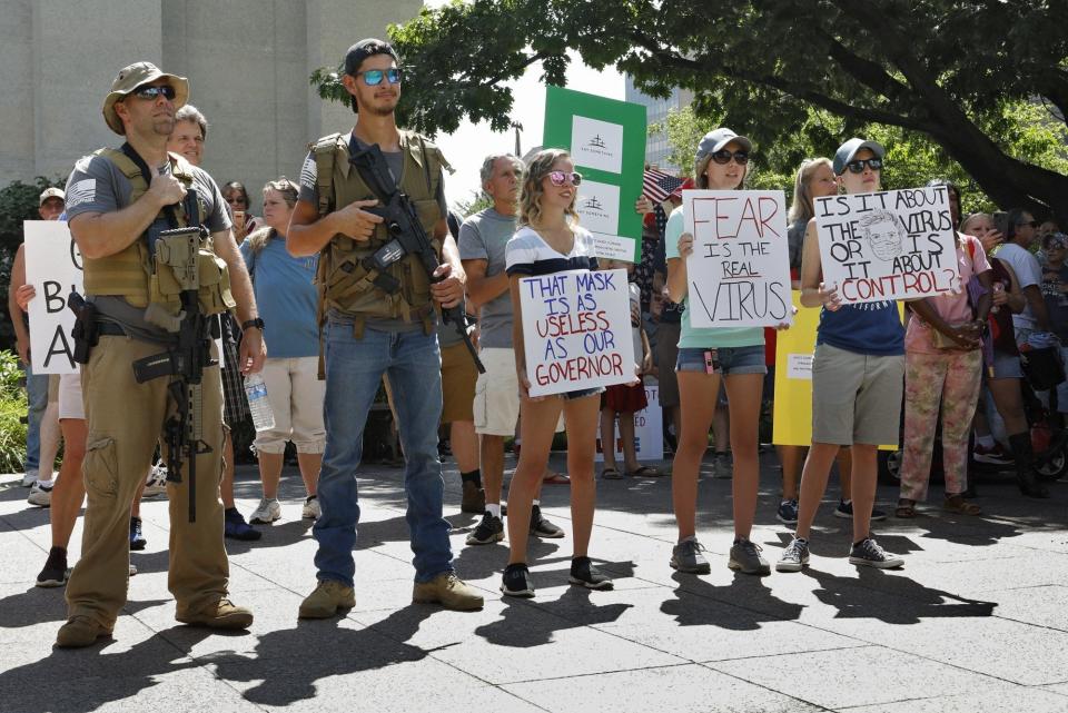 Militia members and anti-mask protesters listened to speeches July 18, 2020 outside the Ohio Statehouse. The rally, called "Stand Up For America," attracted about 300 people and groups opposing masks during the deadly COVID pandemic, protesting what they described as "the tyranny of the government."